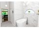 Stunning bathroom with freestanding tub, marble tile, statement lighting, and access to the main bedroom at 341 Sprucewood Rd, Lake Mary, FL 32746