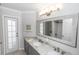 Stylish bathroom with double sinks, granite countertop, and decorative mirror at 341 Sprucewood Rd, Lake Mary, FL 32746