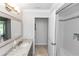 Bright bathroom showcasing tile shower, vanity, and decorative mirror at 341 Sprucewood Rd, Lake Mary, FL 32746