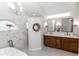 Bathroom featuring double vanity with dark wood cabinets, marble tiling, and freestanding tub at 341 Sprucewood Rd, Lake Mary, FL 32746