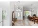 Welcoming foyer featuring tile flooring, a decorative mirror, and a view into the dining area, creating a grand entrance at 341 Sprucewood Rd, Lake Mary, FL 32746