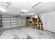 Spacious garage featuring storage racks, work bench, and ample room for parking at 341 Sprucewood Rd, Lake Mary, FL 32746