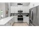 Bright kitchen with white cabinets, stainless steel appliances, and stylish backsplash at 341 Sprucewood Rd, Lake Mary, FL 32746