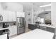 Open-concept kitchen with stainless steel appliances and a view into the living room at 341 Sprucewood Rd, Lake Mary, FL 32746