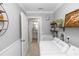 Clean laundry room with white washer, dryer, and adjacent half bathroom at 341 Sprucewood Rd, Lake Mary, FL 32746
