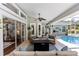 Inviting screened-in patio with comfortable seating, a fire pit, and views of the pool, perfect for entertaining at 341 Sprucewood Rd, Lake Mary, FL 32746