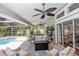 Comfortable screened-in patio with ceiling fans, stylish seating, and views of the pool and backyard at 341 Sprucewood Rd, Lake Mary, FL 32746