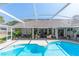 Relaxing screened-in patio area overlooking a sparkling pool, offering a perfect spot for outdoor living and entertaining at 341 Sprucewood Rd, Lake Mary, FL 32746