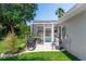 Outdoor entertaining in a screened in pool area with a grill and lounge furniture at 341 Sprucewood Rd, Lake Mary, FL 32746