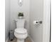 Cozy powder room featuring a modern toilet, wall decor, and neutral tones at 341 Sprucewood Rd, Lake Mary, FL 32746