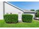 A quaint side entrance framed by manicured hedges, creating a private walkway at 341 Sprucewood Rd, Lake Mary, FL 32746