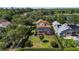 Aerial view of a backyard with a screened pool, patio furniture, and lush landscaping at 402 S Lake Victoria Cir, Deland, FL 32724