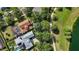 Beautiful aerial view of a property with a pool, lush greenery, and a serene lake nearby at 402 S Lake Victoria Cir, Deland, FL 32724