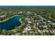 Aerial view of a lakefront neighborhood with mature trees and community swimming pool at 402 S Lake Victoria Cir, Deland, FL 32724