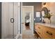 Bathroom featuring a large shower, dual sinks, a wood vanity, and stylish tile flooring at 402 S Lake Victoria Cir, Deland, FL 32724