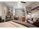 Bedroom featuring surfboards, a ceiling fan, a desk, and a comfortable leather couch at 402 S Lake Victoria Cir, Deland, FL 32724