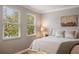 Bright bedroom featuring large windows providing ample natural light, complemented by neutral tones and comfortable furnishings at 402 S Lake Victoria Cir, Deland, FL 32724