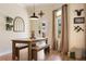 Light-filled dining area with a rustic wooden table, views to the outside pool, and stylish decor at 402 S Lake Victoria Cir, Deland, FL 32724