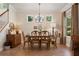 Traditional dining room features a wood table, chandelier, and ample natural light at 402 S Lake Victoria Cir, Deland, FL 32724