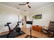 Exercise room with a stationary bike, rocker, ceiling fan, and laminate floors at 402 S Lake Victoria Cir, Deland, FL 32724