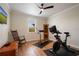 Home exercise room with a stationary bike, rower, ceiling fan, and hard wood floors at 402 S Lake Victoria Cir, Deland, FL 32724