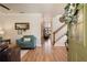 Bright foyer features wood floors, a staircase with wooden banister and open doorway leading to living area at 402 S Lake Victoria Cir, Deland, FL 32724