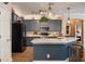 Modern kitchen with quartz counters, dark cabinets, and stainless appliances at 402 S Lake Victoria Cir, Deland, FL 32724