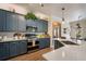 Well-lit kitchen features stainless appliances, quartz countertops, stylish cabinetry, and modern lighting at 402 S Lake Victoria Cir, Deland, FL 32724