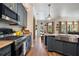 Open kitchen with stainless appliances, quartz countertops, and seamlessly connects to an outdoor pool area at 402 S Lake Victoria Cir, Deland, FL 32724