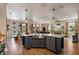 Open kitchen with stainless appliances, quartz counters, modern pendant lighting and seamlessly connects to living spaces at 402 S Lake Victoria Cir, Deland, FL 32724