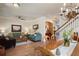 Open concept living and dining area with wood floors, chandelier, and teal furniture at 402 S Lake Victoria Cir, Deland, FL 32724