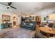 Cozy living room featuring comfortable seating, rug, and kitchen area at 402 S Lake Victoria Cir, Deland, FL 32724
