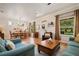 Open concept living room and dining area with wood floors, neutral paint and large windows at 402 S Lake Victoria Cir, Deland, FL 32724