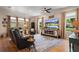 Comfortable living room with large windows and a modern entertainment center at 402 S Lake Victoria Cir, Deland, FL 32724