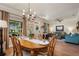 Open concept living space with wood floors, chandelier, and large windows for natural lighting at 402 S Lake Victoria Cir, Deland, FL 32724