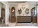 Elegant main bathroom featuring dual vanities, custom mirrors, wood cabinetry, and a shiplap accent wall at 402 S Lake Victoria Cir, Deland, FL 32724