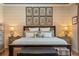 Close up of main bedroom showcasing the bed, side tables, and coordinating fern artwork at 402 S Lake Victoria Cir, Deland, FL 32724