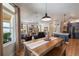 Spacious, open concept living and dining space featuring hardwood floors, modern lighting, and comfortable furnishings at 402 S Lake Victoria Cir, Deland, FL 32724