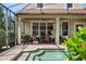 A charming covered patio area with seating, greenery, and easy access to the refreshing pool, perfect for relaxation and entertainment at 402 S Lake Victoria Cir, Deland, FL 32724