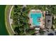 Aerial view of a community pool with lounge chairs, shade, and adjacent parking at 402 S Lake Victoria Cir, Deland, FL 32724