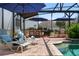 An outdoor oasis featuring lounge chairs, a built-in bar, and a covered seating area, perfect for entertaining or relaxing by the pool at 402 S Lake Victoria Cir, Deland, FL 32724