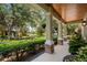 Inviting front porch with classic columns and views of the landscaped garden and lakeside park at 402 S Lake Victoria Cir, Deland, FL 32724