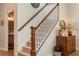 Staircase with wooden banister leads upstairs, with a view of the downstairs powder room at 402 S Lake Victoria Cir, Deland, FL 32724