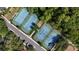 Aerial view of tennis courts in a well-maintained community surrounded by lush greenery and trees at 402 S Lake Victoria Cir, Deland, FL 32724