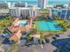 Aerial view of a pool, tennis courts, and shuffleboard court near the beach at 5300 S Atlantic Ave # 6-507, New Smyrna Beach, FL 32169