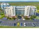 Aerial view of condominium building showing balconies, covered parking, and surrounding green space at 5300 S Atlantic Ave # 6-507, New Smyrna Beach, FL 32169