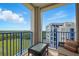 Relaxing balcony with seating, glass table, and views of lush green space at 5300 S Atlantic Ave # 6-507, New Smyrna Beach, FL 32169