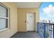 Balcony view featuring front door, windows, and outdoor space with blue railings at 5300 S Atlantic Ave # 6-507, New Smyrna Beach, FL 32169