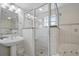 Bathroom features a large glass enclosed shower, pedestal sink, and jacuzzi tub at 5300 S Atlantic Ave # 6-507, New Smyrna Beach, FL 32169