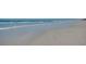 Expansive beach view showcasing the serene shoreline and crystal-clear waters, perfect for relaxation at 5300 S Atlantic Ave # 6-507, New Smyrna Beach, FL 32169